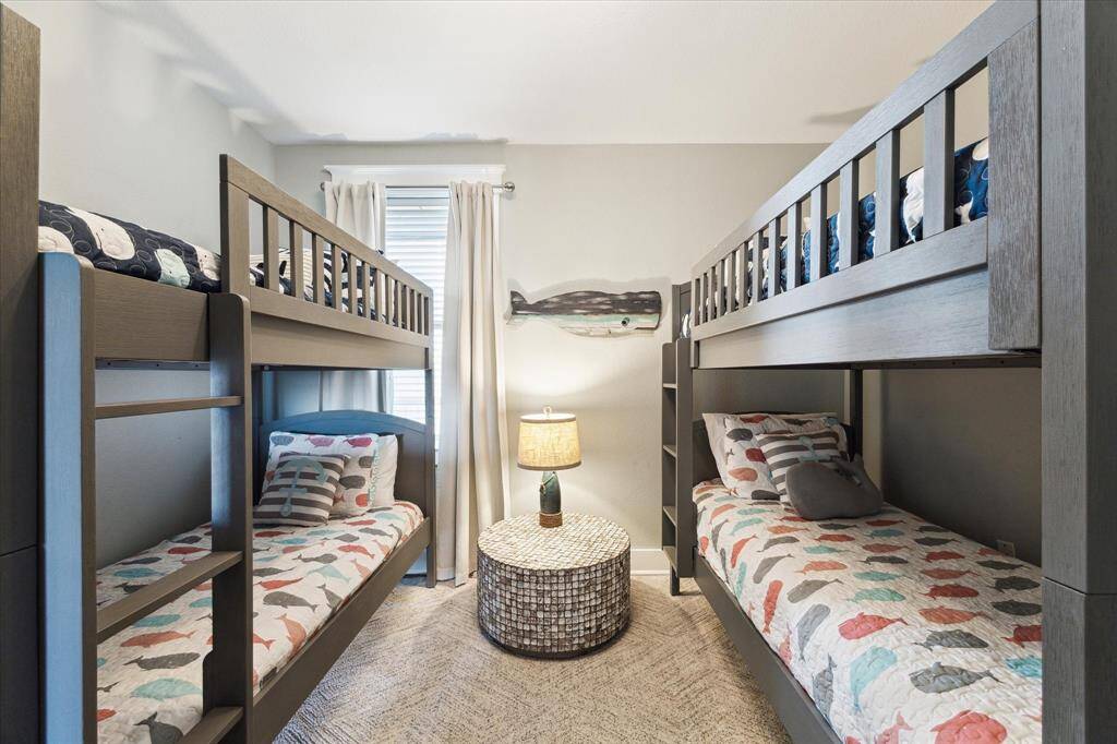 Bedroom #3 has wood floor, rug, and removable bunk beds.