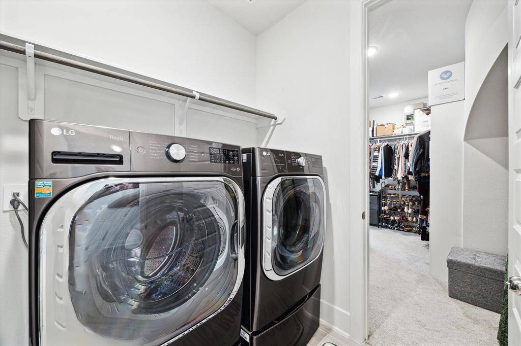 The laundry room opens from the hallway as well as into the master bedroom closet. This makes it convenient for putting away your clothes!!
