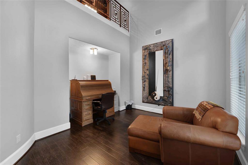 The spacious home office features soaring ceilings, rich wood floors, and soO paint colors, creaOng a perfect atmosphere for dedicated work or study. A deep nook provides an ideal space for a desk or shelving, making it both functional and stylish
