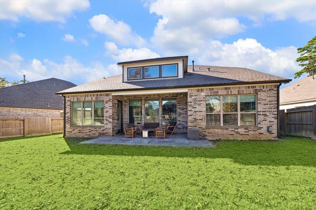 This view from the back of the house shows the extended concrete stained patio! There's plenty of room to play and landscape!