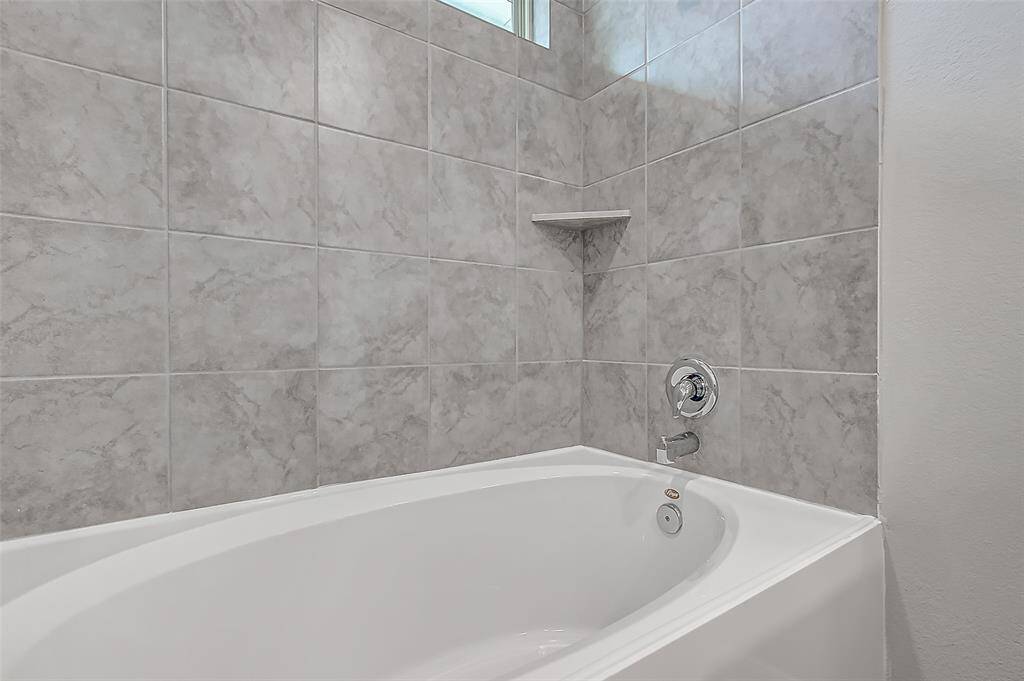 Fully tiled, generous sized shower and tub.