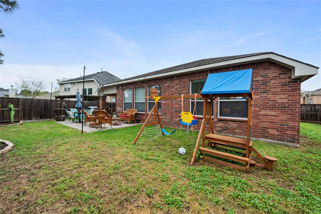 You still have plenty of grass beyond patio and down side of house with this wide lot. It can be used for a kid's play yard, your garden, and all the outdoor activities at your little slice of heaven in Gleannloch Farms!