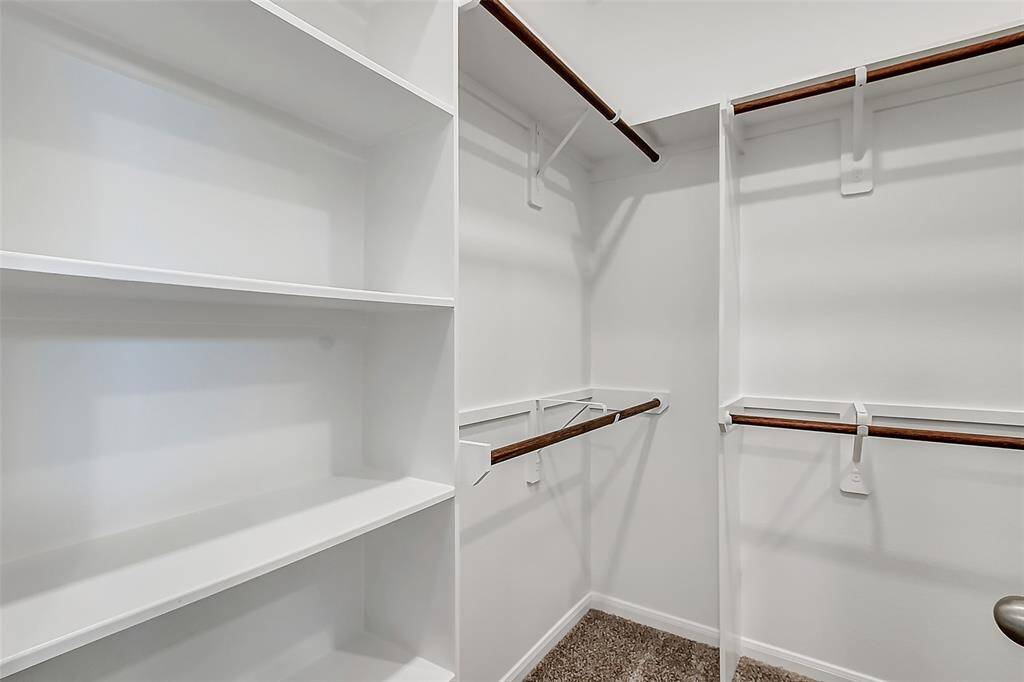 Spacious primary closet is large enough to store all your stuff.