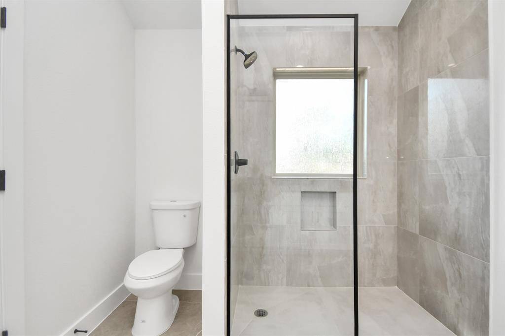 Primary Bath shower and toilet.