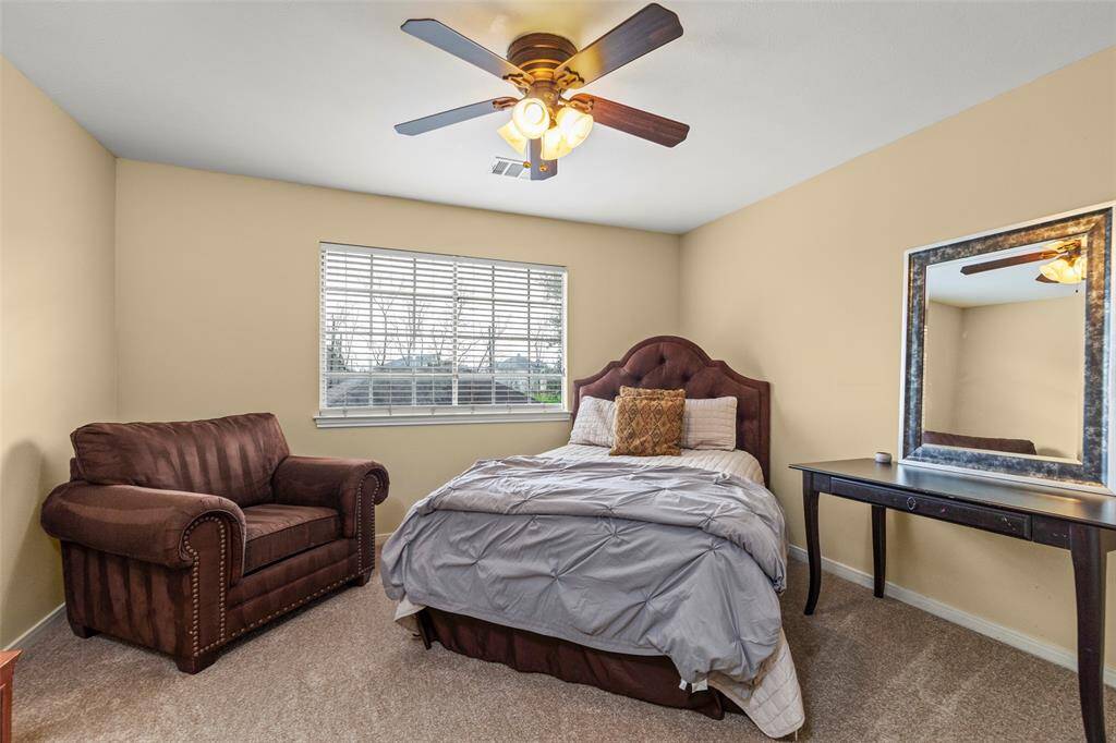 Comfortable Bedroom Features Neutral Walls and a Large Window Providing Natural Light.
