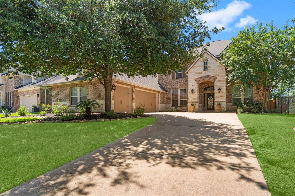 A Wide driveway leads to a spacious three-car garage, offering plenty of parking and storage space.