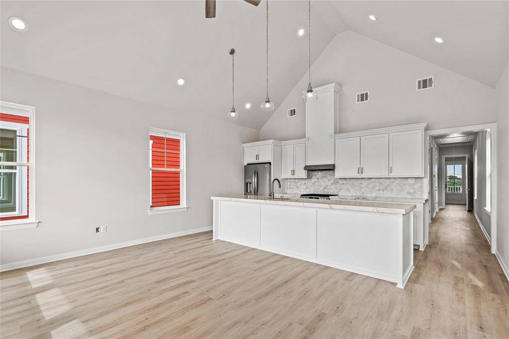 Open concept with plenty of space for seating on island.