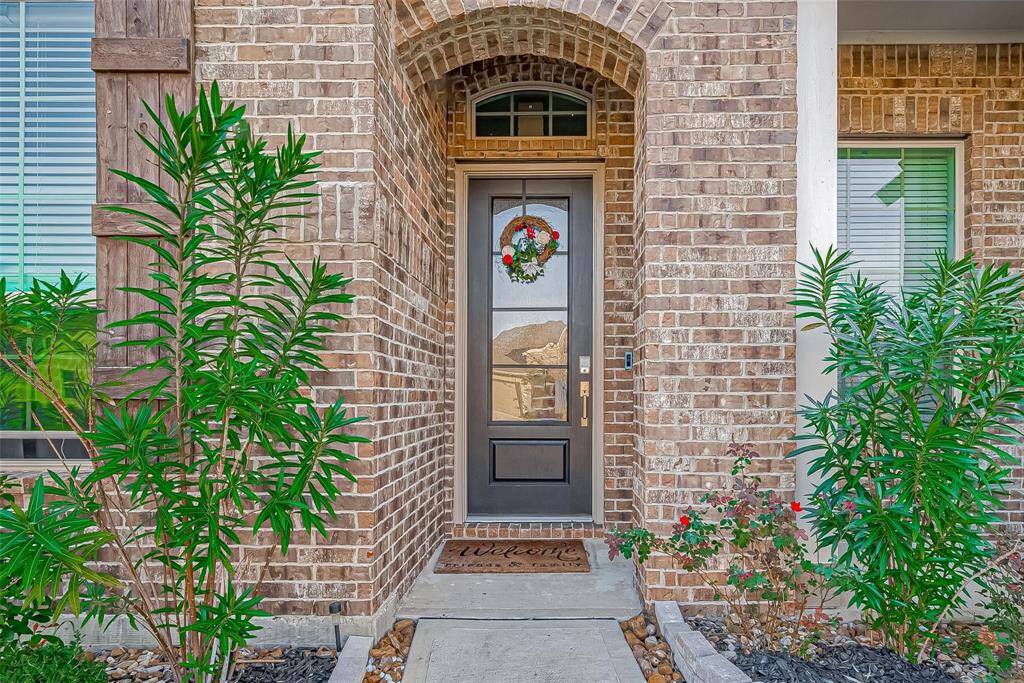 As you walk up to the covered front porch, you are greeted by the modern front entry.