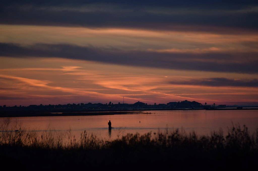 Wade fishing at Sunset in front of the building