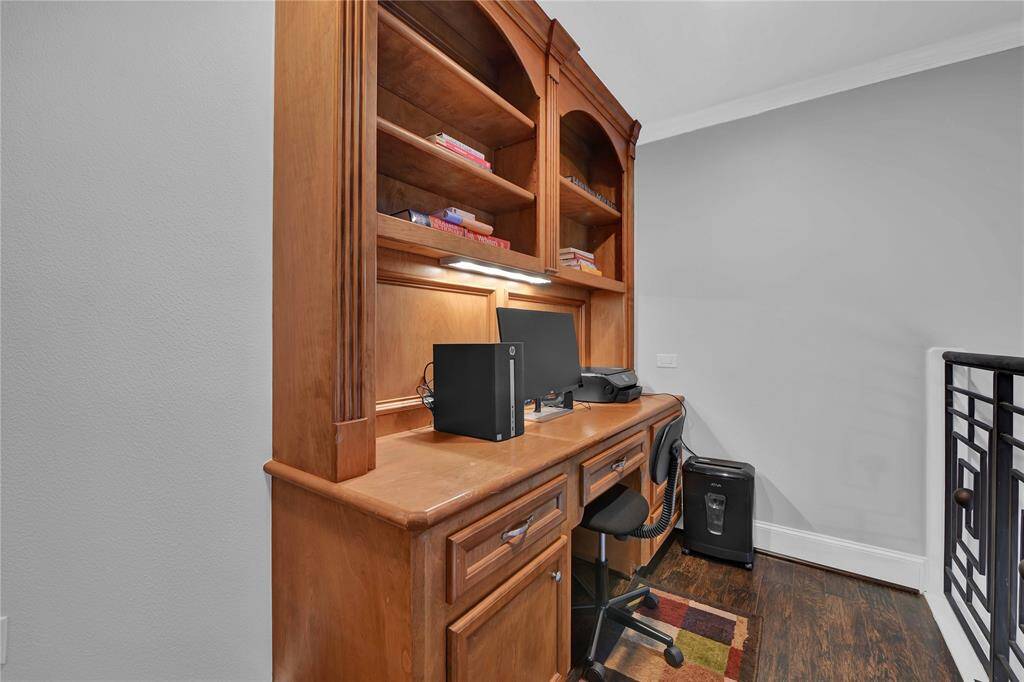 This inviOng game room is designed for both relaxaOon and entertainment, featuring gleaming wood floors that add warmth and elegance to the space. A high tray ceiling adorned with recessed lighOng and a stylish modern fan creates an airy ambiance, while crown molding adds a sophisOcated touch to the room's aestheOc.