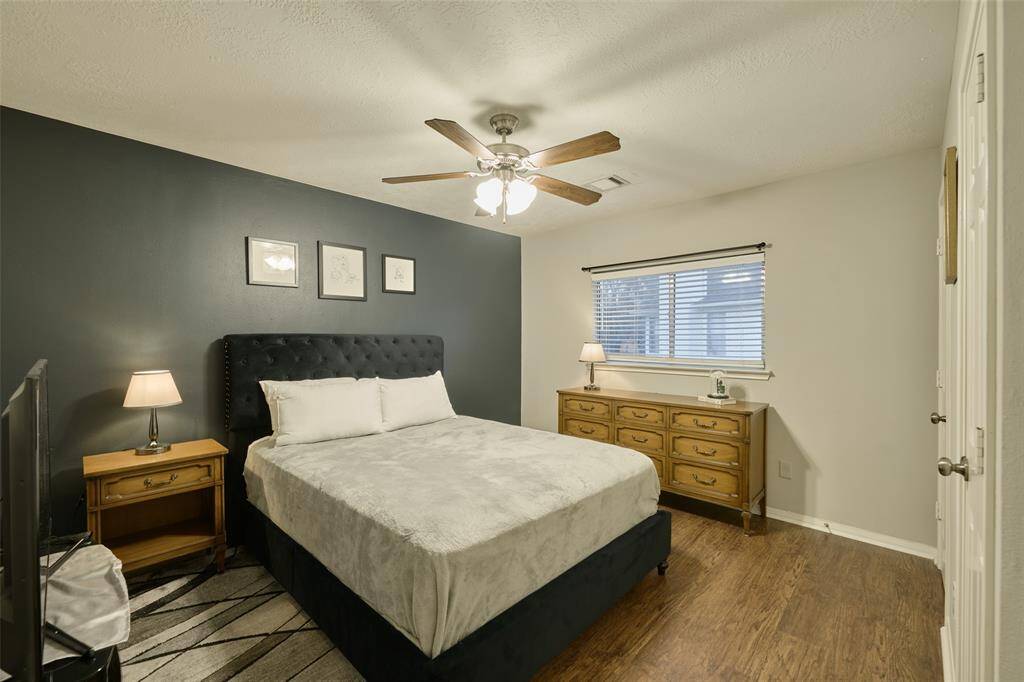 This beautiful secondary bedroom on the 2nd floor features a ceiling fan and luxury vinyl plank flooring.