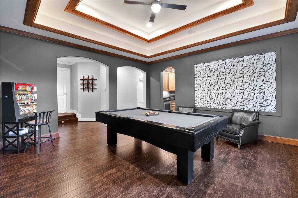 For added convenience, the game room is equipped with a wet bar complete with a refreshment fridge, making it easy to serve drinks and snacks while entertaining guests. Whether hosOng game nights or simply enjoying a quiet evening in, this versaOle space offers everything you need for an enjoyable lifestyle.