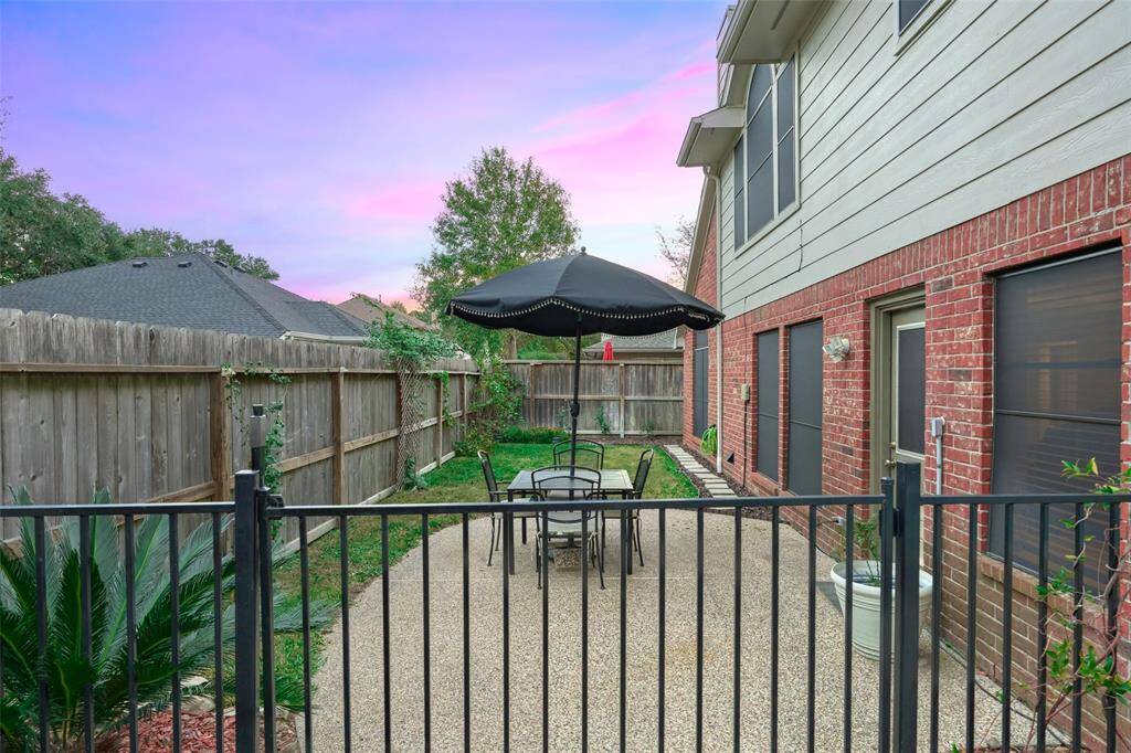 The property is fully fenced with a side patio.