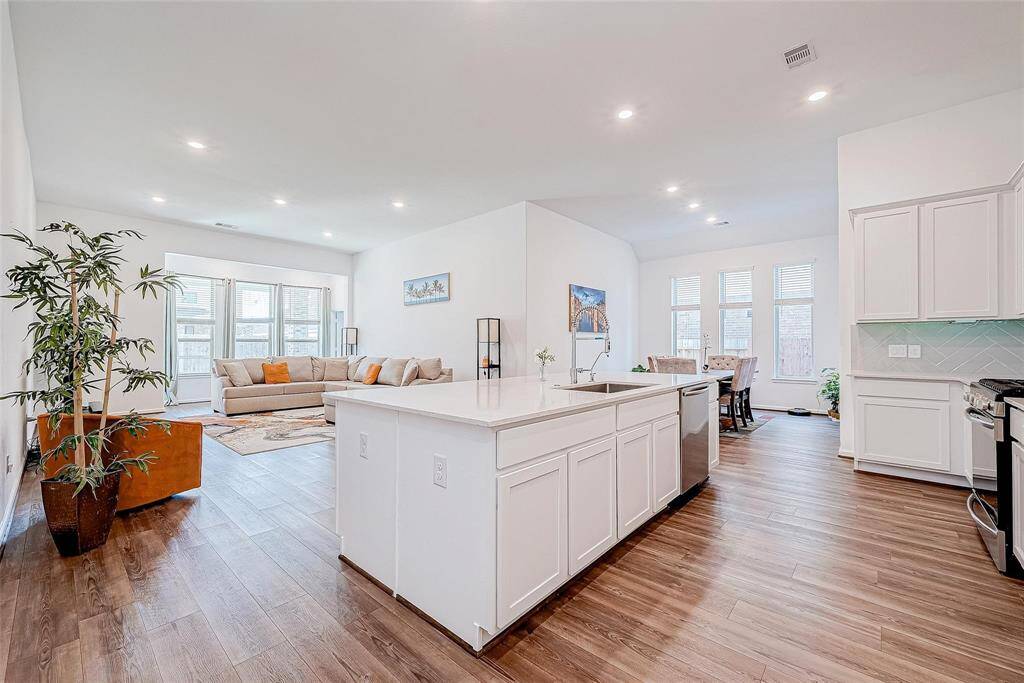Bright and airy living room that is open to the kitchen and dining space. Perfect for entertaining!