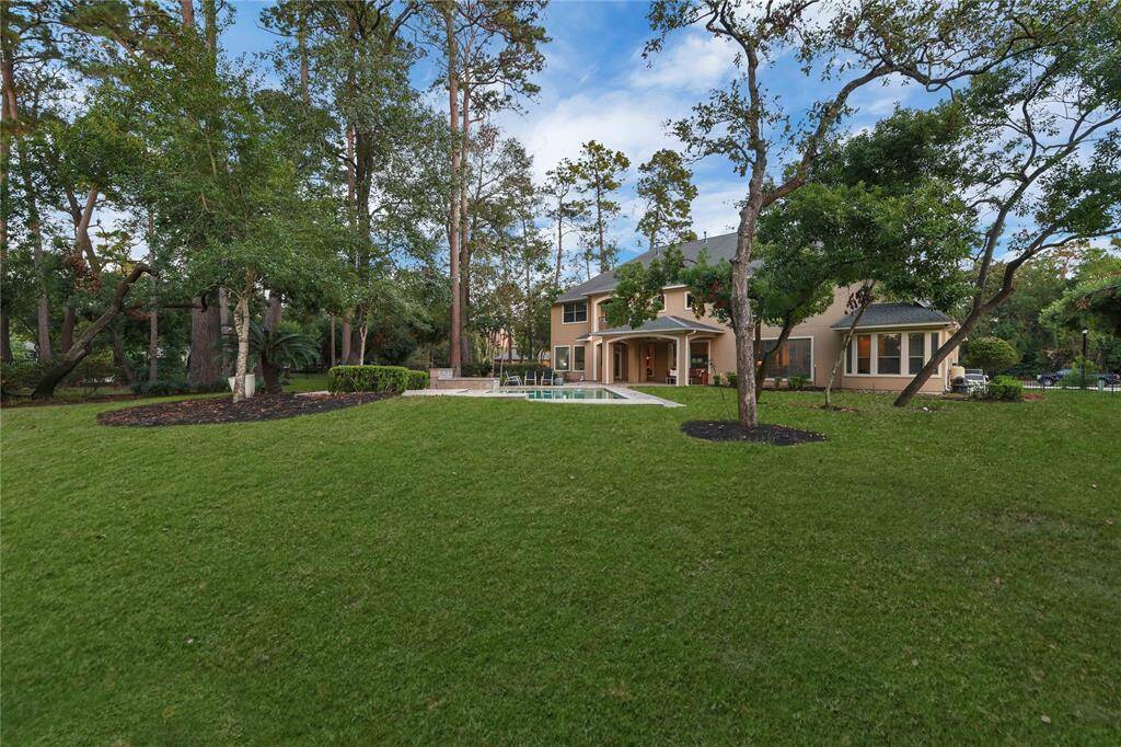 A charming walkway, lined with spaced stepping stones, leads to a tranquil picnic area nestled among soaring trees, creaOng an inviOng oasis for outdoor gatherings and relaxation.