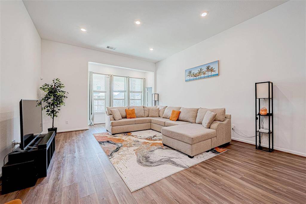 Bright and airy living room that is open to the kitchen and dining space. Perfect for entertaining!
