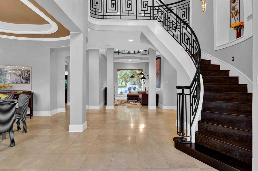From the moment you step into the grand entryway, you are welcomed by masterful architecture and exquisite decorator details. The space features sleek Ole flooring, soaring ceilings, and an elegant curved wooden staircase, setng the tone for the luxurious design and craOsmanship that flows throughout the home.