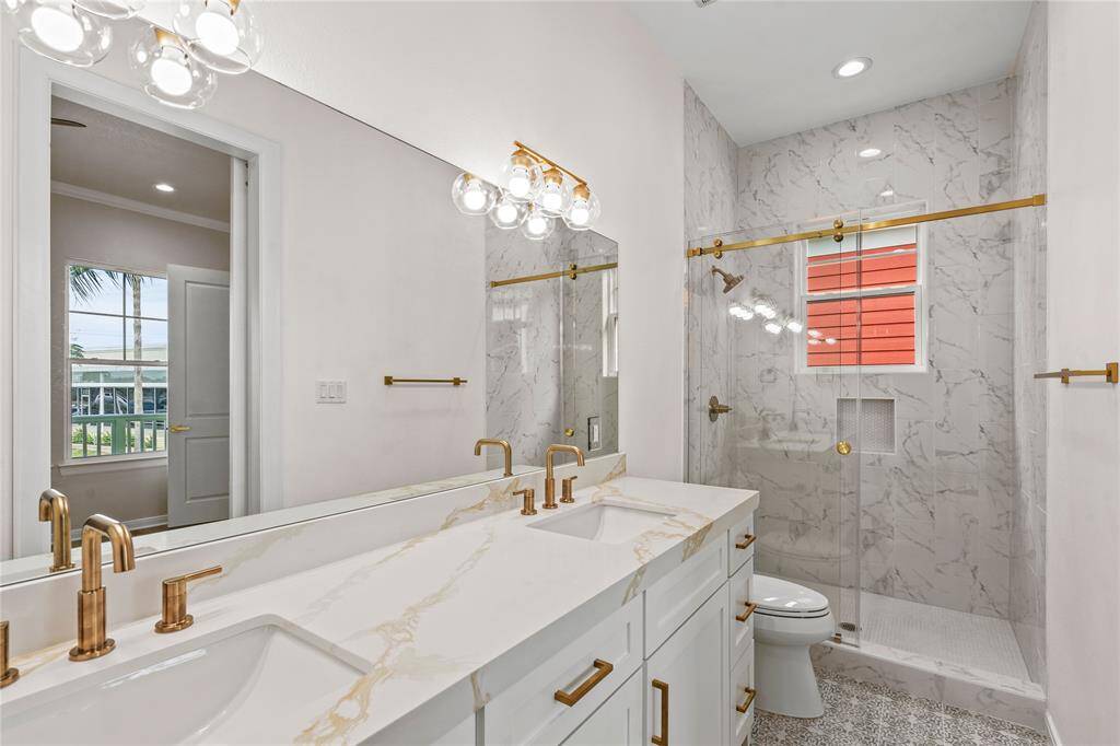 Primary bath with walk in shower adorned with designer finishes.