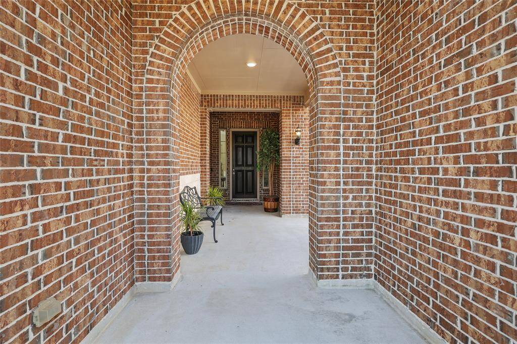 The brick arches of the courtyard welcome you to the front entrance.