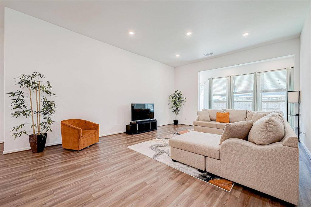 Bright and airy living room that is open to the kitchen and dining space. Perfect for entertaining!
