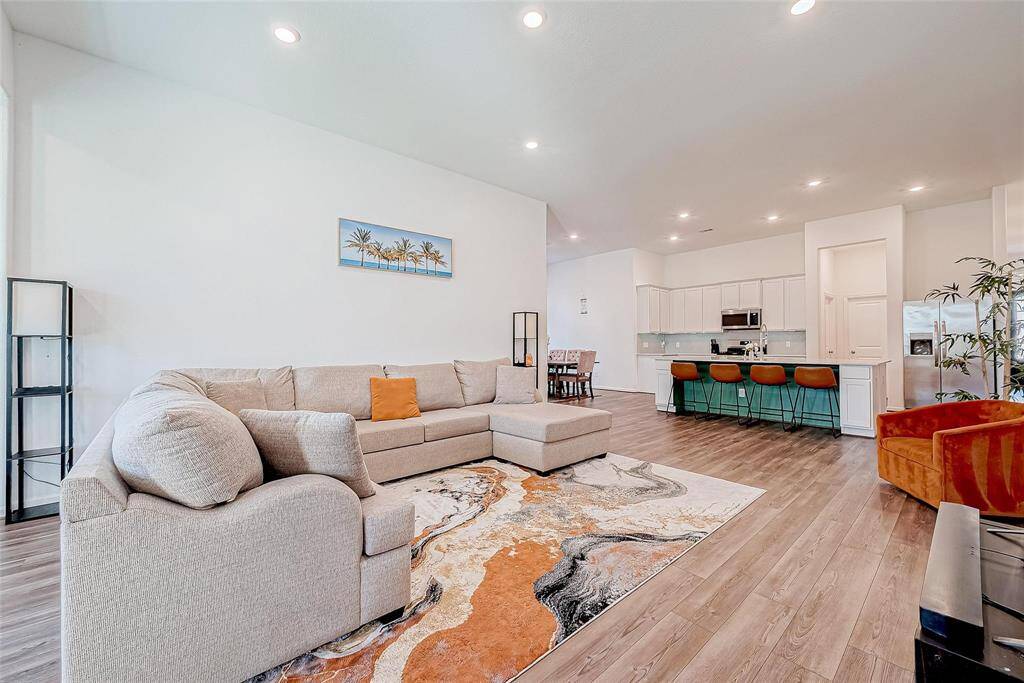 Bright and airy living room that is open to the kitchen and dining space. Perfect for entertaining!