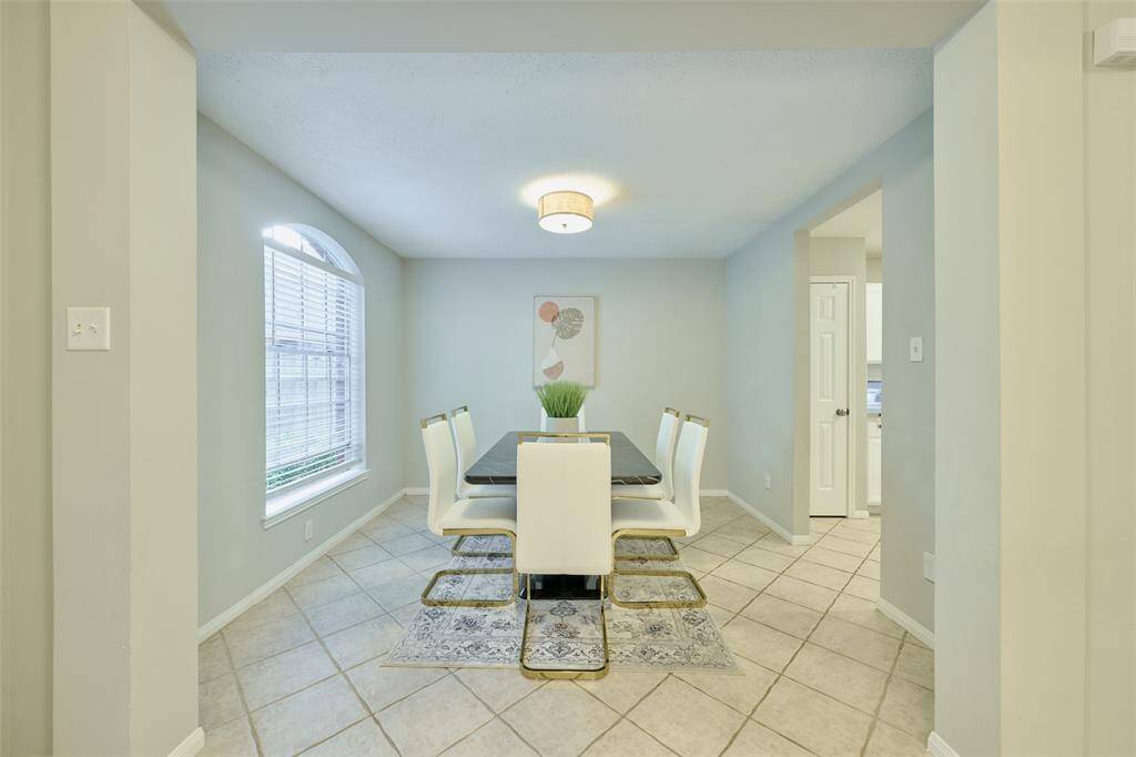 The dining room can be used as a flexible office space with huge window inviting in the natural lighting from outdoors.
