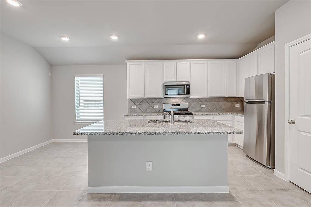 Large kitchen island with counter height seating.