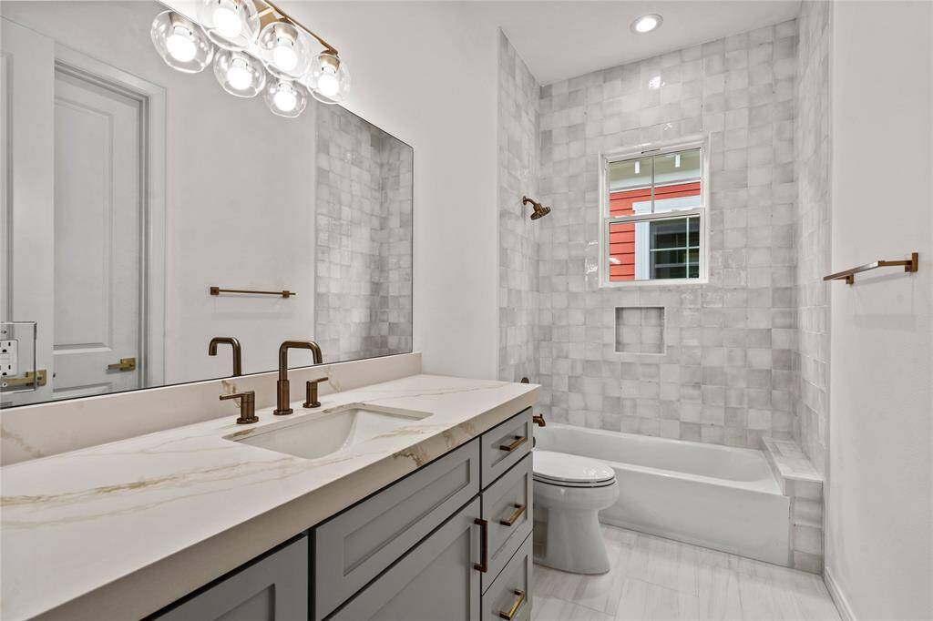 Secondary Bath with a tub and shower.