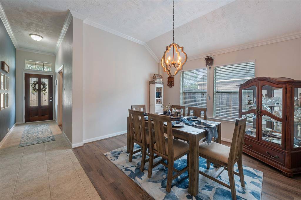 Formal dining room as you enter with updated chandelier and vinyl plank floors! All vinyl and carpet were replaced in 2020!