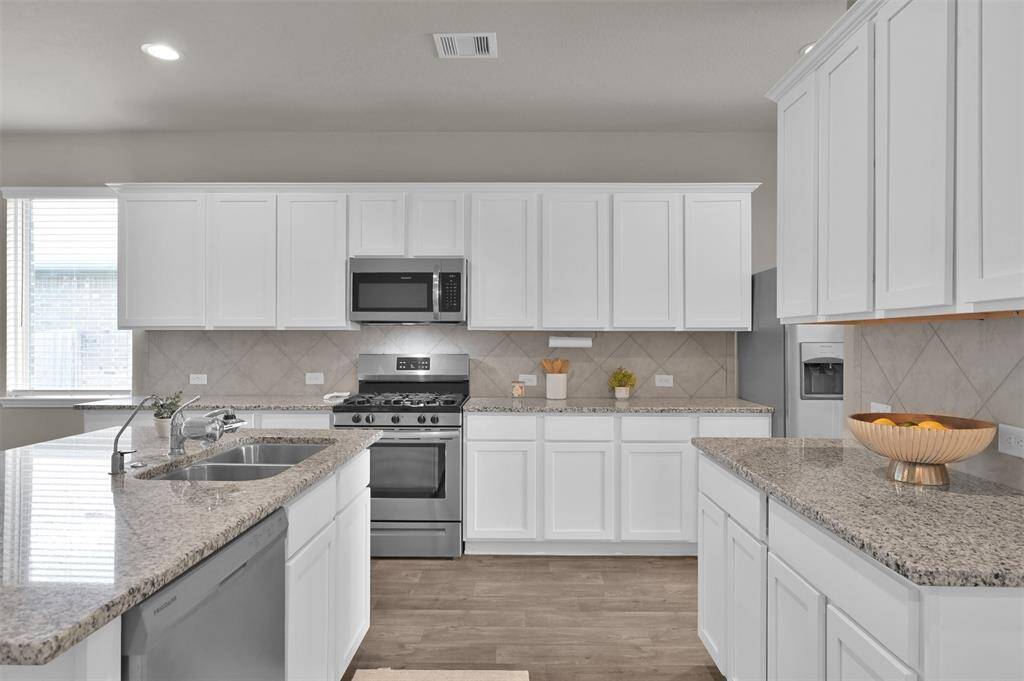This kitchen boasts an ample amount of countertop and storage space!