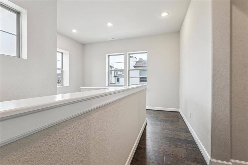 This photos highlight the upstairs landing area, where you'll find three bedrooms and two full bathrooms. This space offers a comfortable and convenient setup for families or guests, providing ample room and privacy.