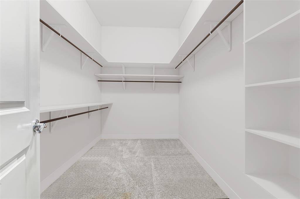 The master closet provides ample space to accommodate both hanging rods and storage for your clothing. This well-organized area ensures that you have enough room to neatly arrange your wardrobe, making it easy to access your garments and keep everything in order. With its thoughtful design, the closet allows for a clear and organized view of your clothing collection, facilitating a more efficient and enjoyable dressing experience.
