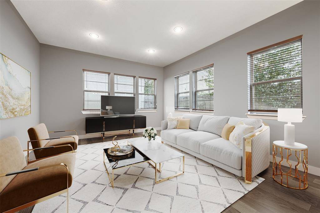 The view of the living room highlights the open floor plan crafted by the architect. This design features elements like window blinds, which are superior to those found in newer constructions that typically lack window coverings. (Digitally Staged)