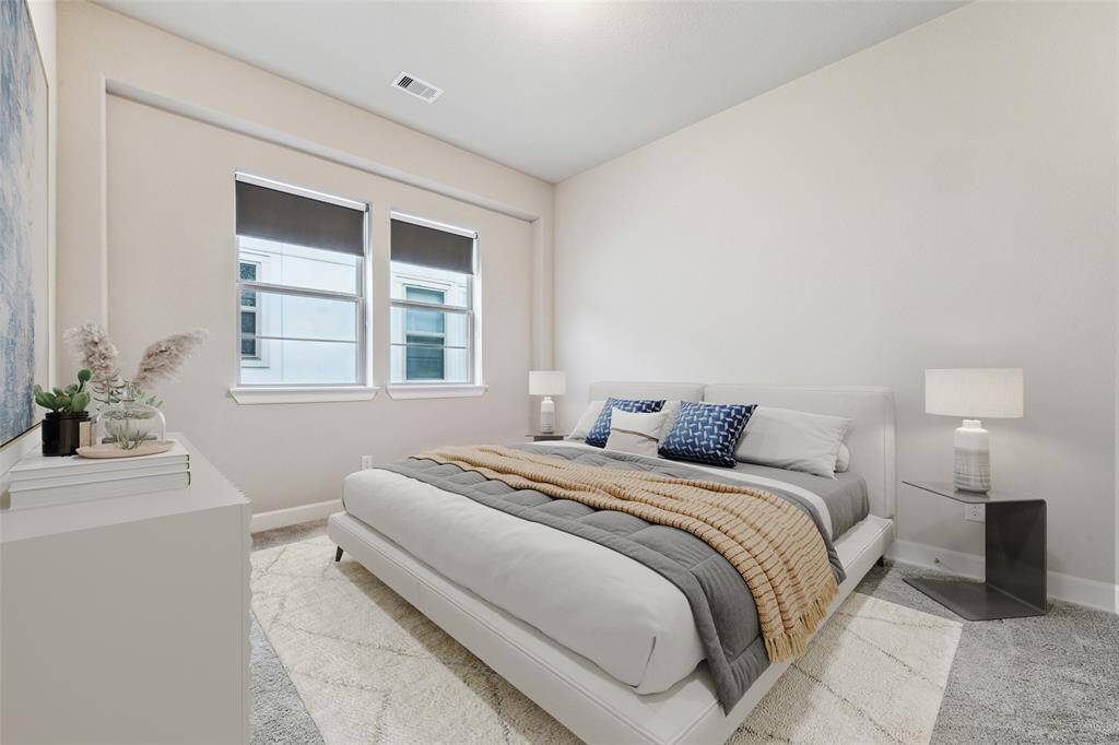 This secondary bedroom is spacious and ideal for accommodating guests. There is a closet on the right side that has not been included in the photo, providing extra storage space for personal items. The room's ample size makes it perfect for comfort and relaxation. (Digitally Staged)