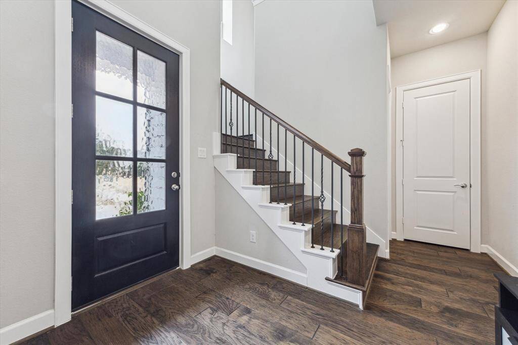 The entrance to the home reveals an open area, featuring a dedicated staircase that ascends to the three bedrooms located on the upper level. The downstairs layout is designed for convenient living, including a living room, dining area, kitchen, and a guest-friendly half bathroom.