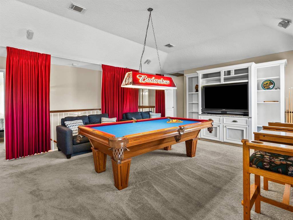 Welcome to your ultimate game room oasis, room for full size pool table, cozy lounge area, and a custom media center ready for your big-screen entertainment. Bathed in natural light and finished with soft, luxurious carpeting, this inviting space is perfect for both relaxing and hosting memorable gatherings.