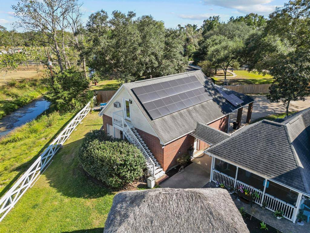 Discover a picturesque two-story residence nestled in lush surroundings, featuring eco-friendly solar panels and a generous yard for the perfect blend of green living and spacious outdoor enjoyment.