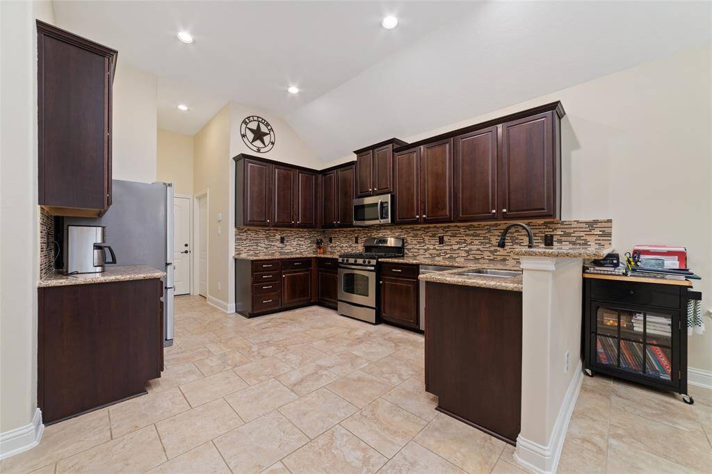 Tile flooring complete this inviting and stylish culinary space.