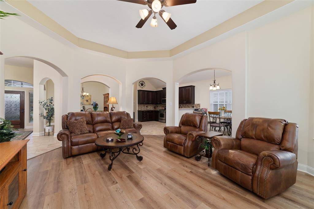 Architectural arches and columns add charm, while the luxury vinyl flooring enhances both durability and style.