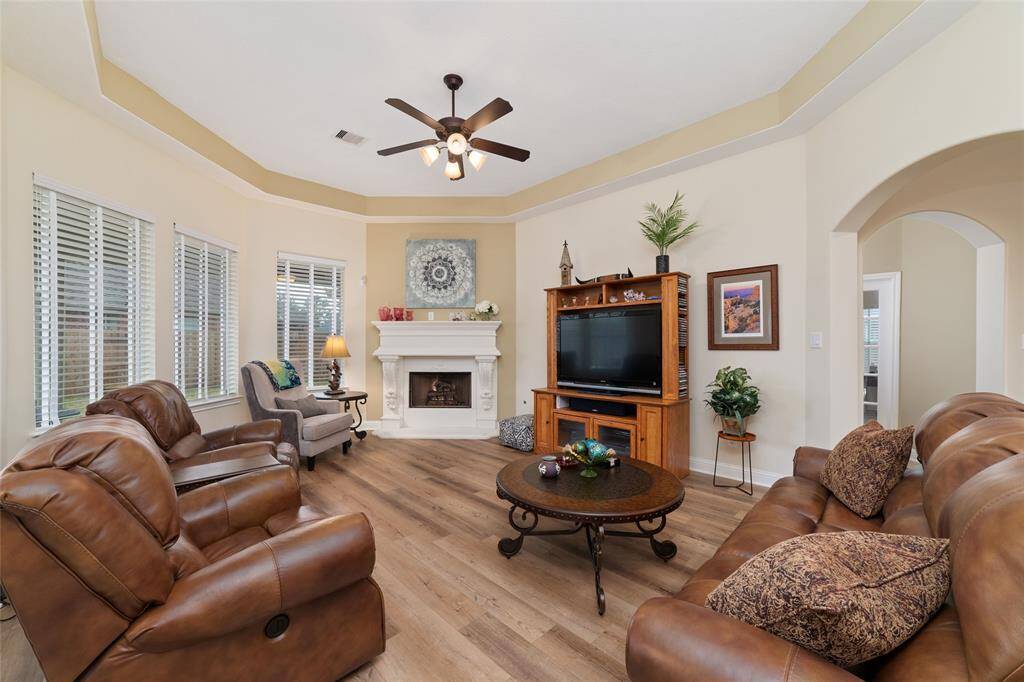 Large windows bring in natural light, making it an ideal space for relaxing or entertaining.