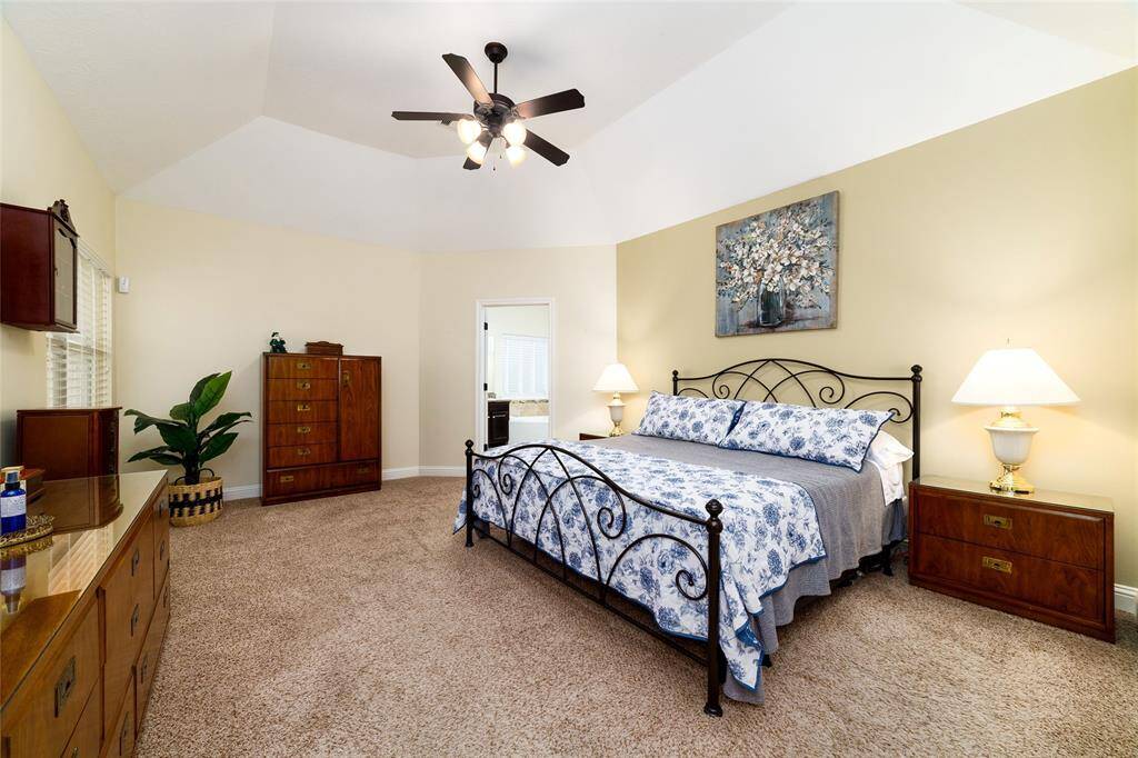 The primary suite is a private retreat, featuring plush carpeting for comfort and dual walk-in closets for ample storage.