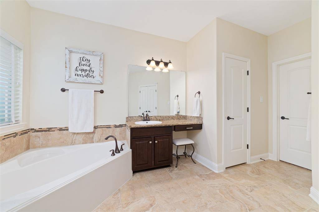 A luxurious soaking tub invites relaxation, perfect for unwinding after a long day.