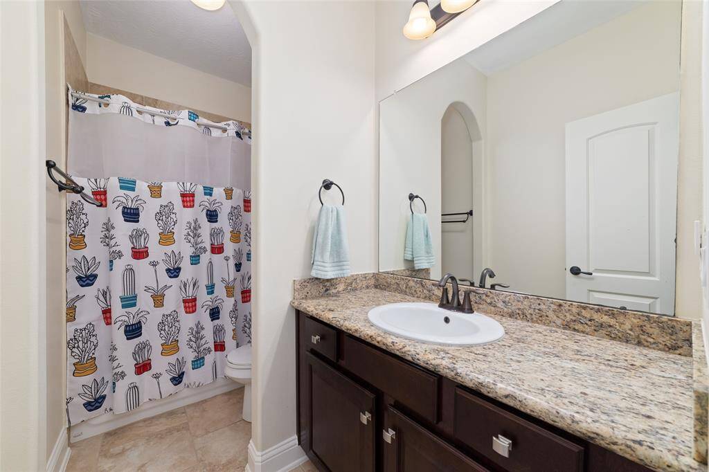 The bathrooms feature tile flooring, sleek granite countertops and a tub/shower combo for a modern touch. Plenty of cabinet space and updated fixtures.