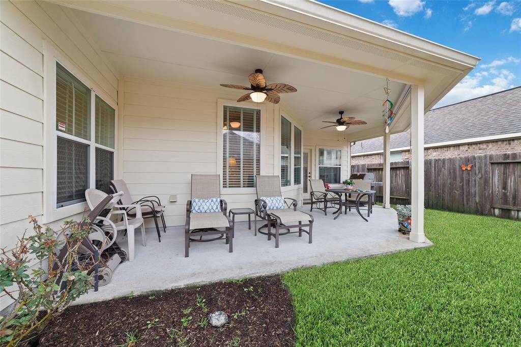 Step onto the covered patio with a ceiling fan for year-round comfort, perfect for entertaining or relaxing.