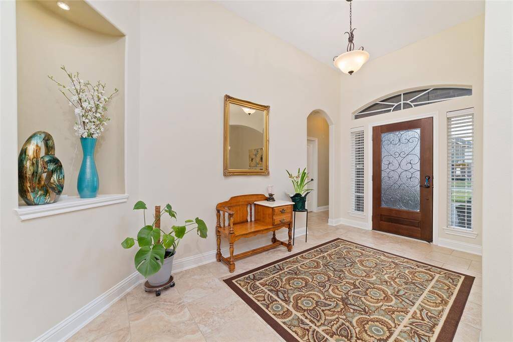 Step into a grand entry foyer, where soaring ceilings and an open layout create an inviting first impression.