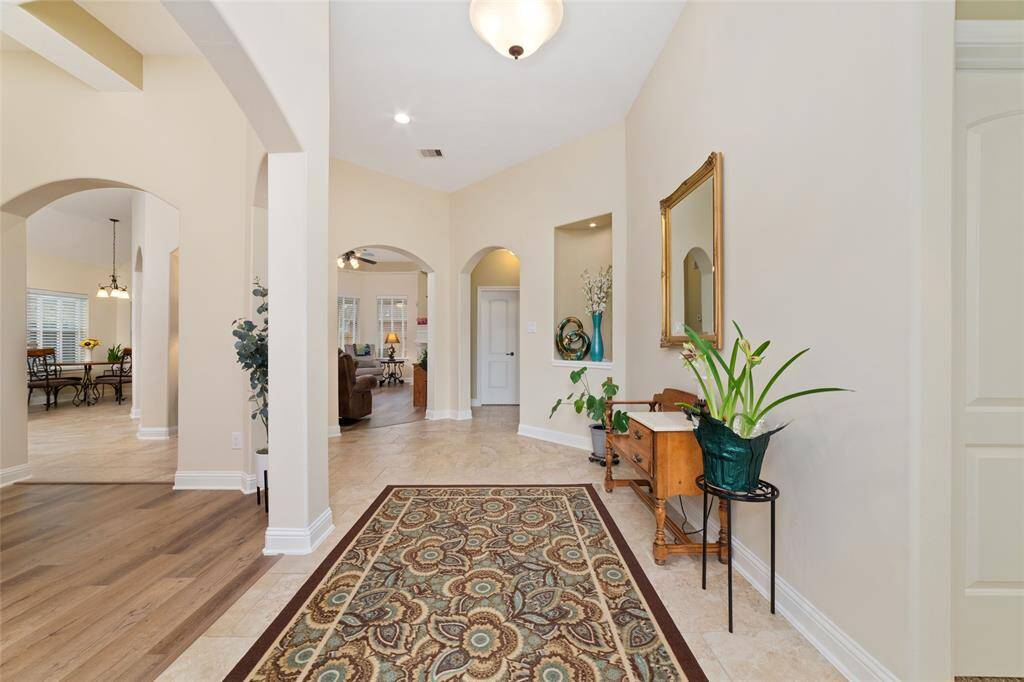 To the right, the secondary bedrooms as well as the home office offer comfort and privacy, tucked away for a peaceful retreat.