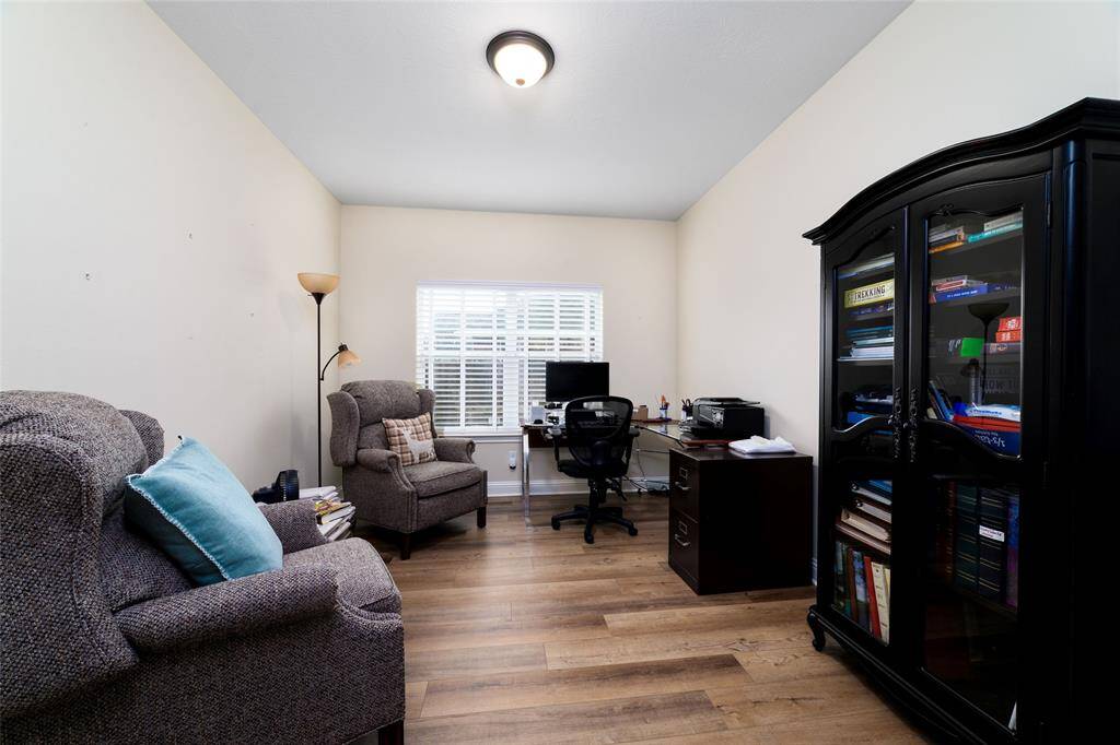 The dedicated home office/study offers a quiet and functional space, perfect for remote work or personal projects. Large windows provide natural light for an inspiring workspace.