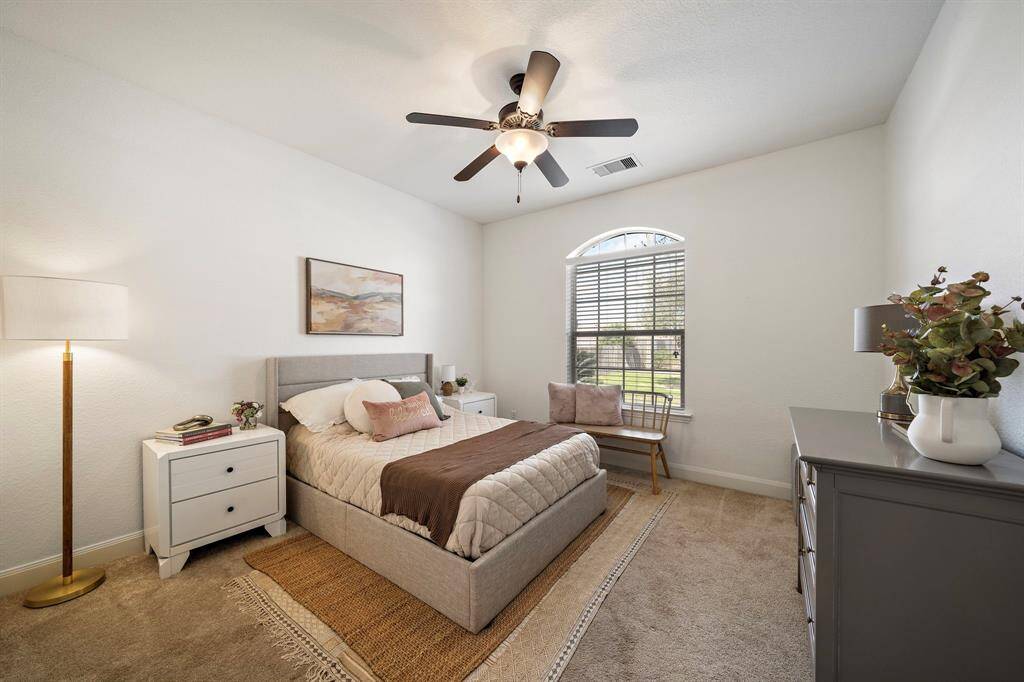 Relax in this inviting bedroom featuring plush carpeting and soft tones. Large windows allow abundant natural light, creating a warm and serene atmosphere. Ideal for personalization, this space offers a restful retreat for relaxation.