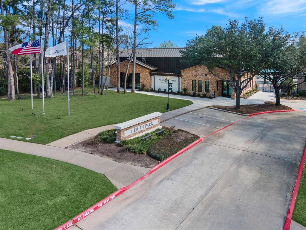 Situated in the amenity-rich Spring Trails community, this inviting clubhouse offers residents access to a refreshing pool, fitness center, and sports courts. The beautifully landscaped surroundings provide an ideal backdrop for gatherings and relaxation, enhancing the neighborhood's appeal.