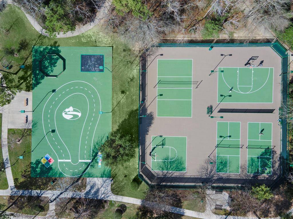 The vibrant Spring Trails community sports court features versatile recreational spaces, including tennis courts and a multi-use area, catering to active living. Surrounded by lush pathways and scenic greenery, it offers an inviting setting for sport enthusiasts and leisurely walks.